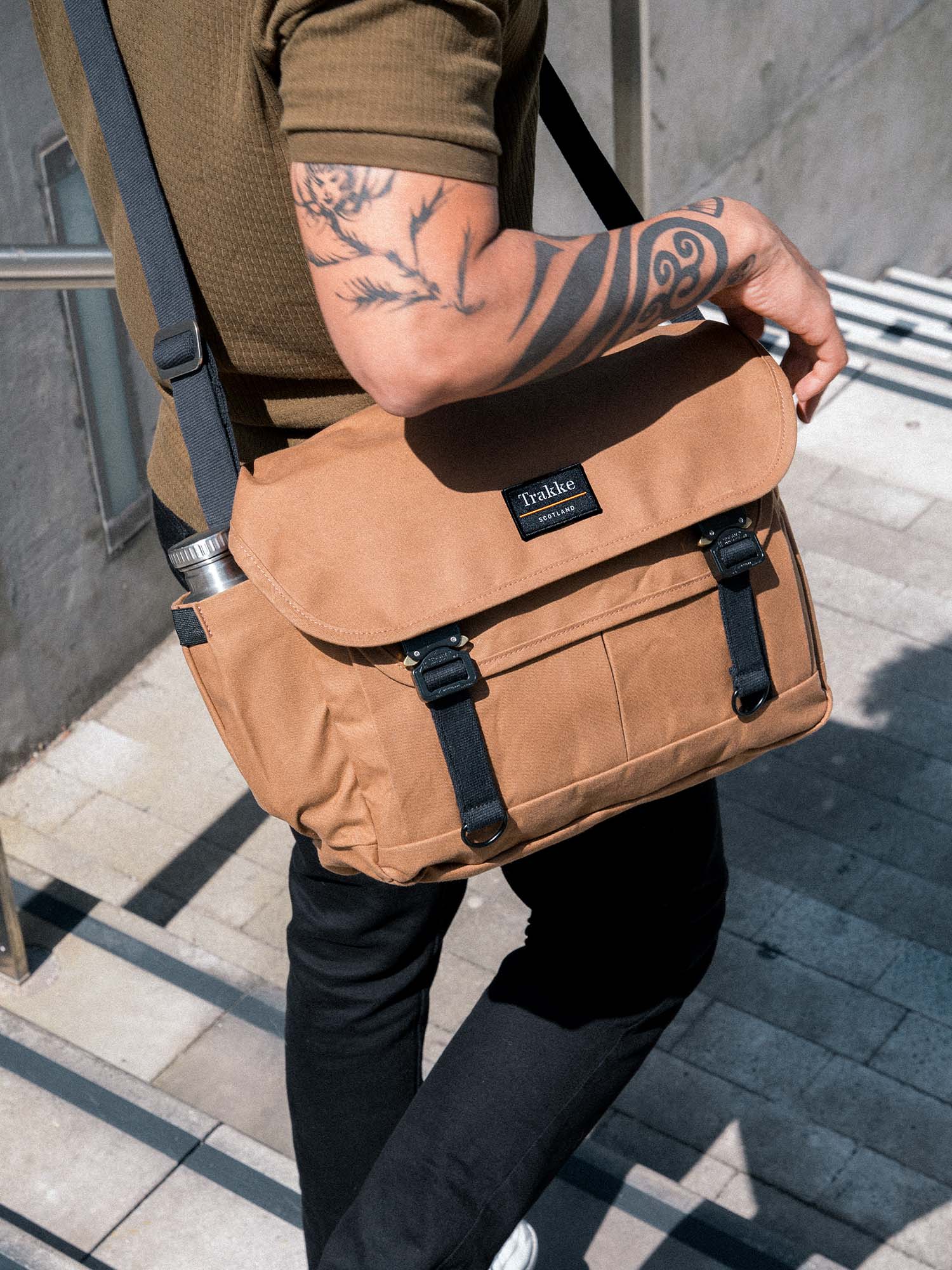 a man walking down stairs with a whisky bairn pro messenger bag