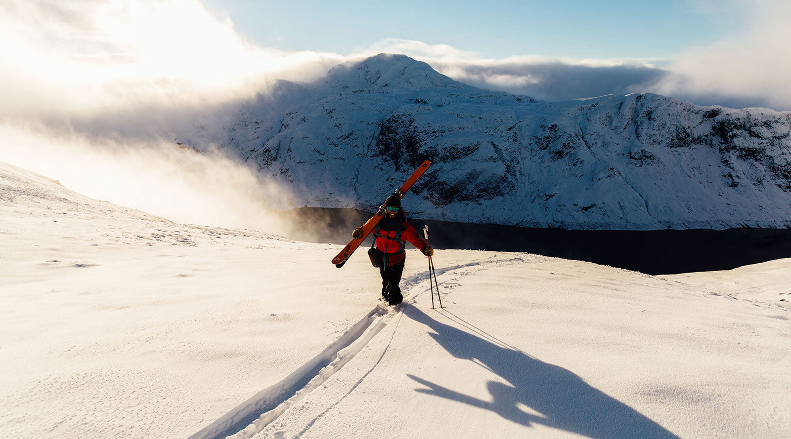 A man in red on a mountain skiing in Scotland