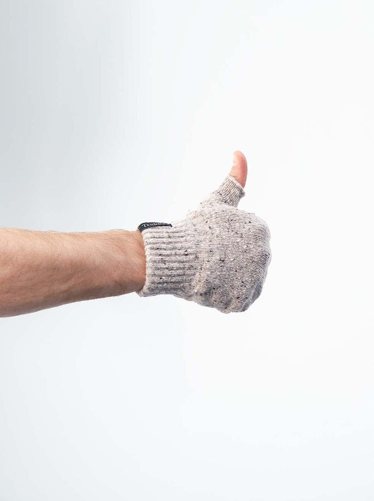 Male hand giving thumbs up wearing a wool fingerless Trakke glove in white wool.